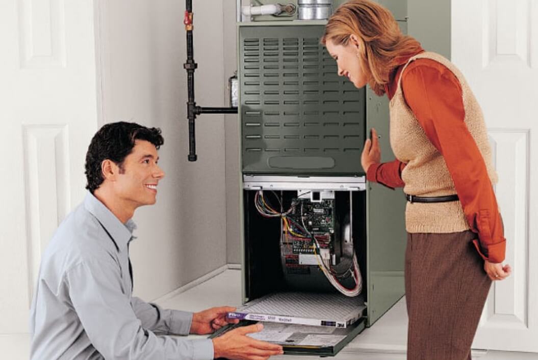Technician inspecting an indoor furnace
