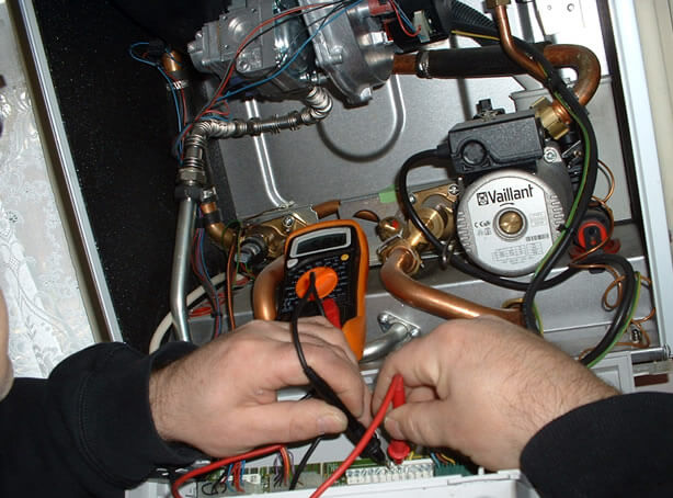 BHMS technician servicing a boiler system