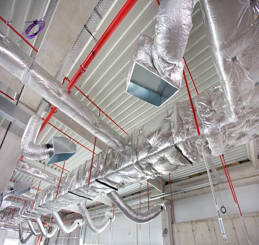 Insulated supply and return ductwork running along a building ceiling