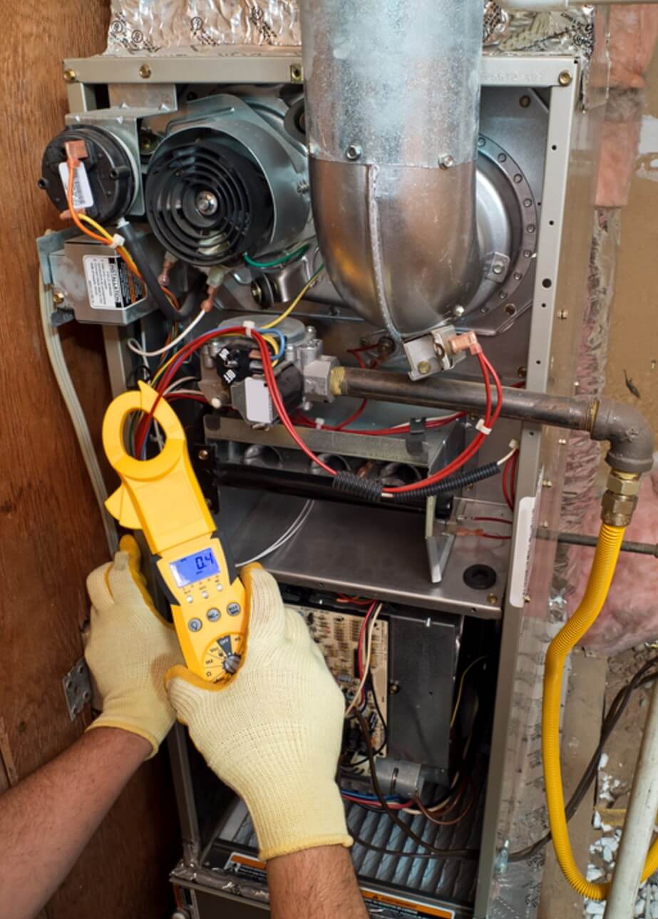 BHMS technician performing preventive maintenance on a furnace