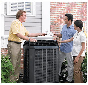 BHMS technician reviewing paperwork with homeowners next to an AC unit