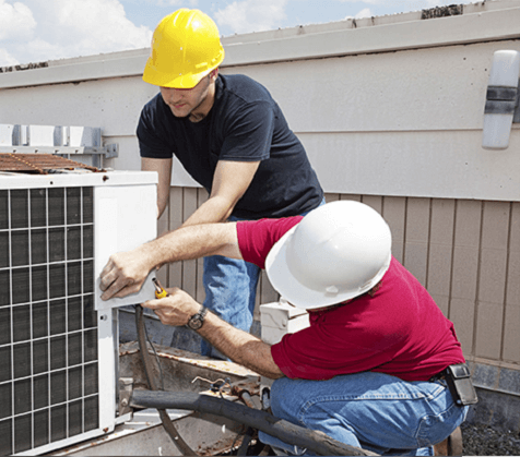 Technicians servicing an outdoor HVAC unit