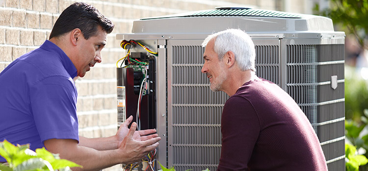 BHMS technician servicing an outdoor AC unit with a homeowner